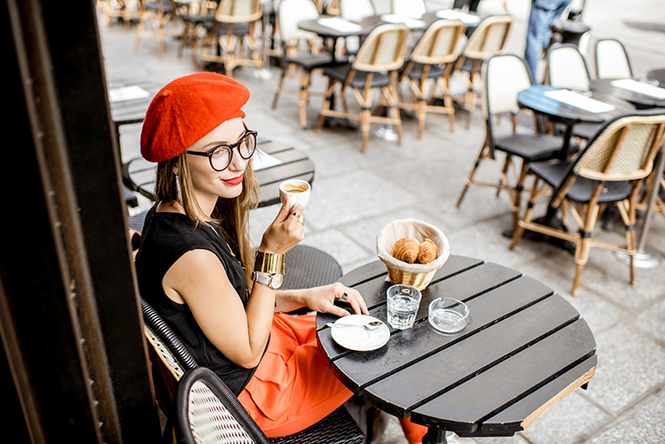 Woman having a french breakfast at the cafe