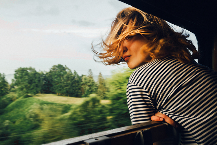 Woman looking at the view from train